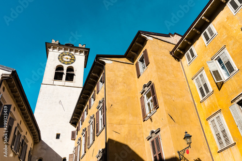 Tableau sur toile Colorful houses and tower with clock in  Rovereto, Italy