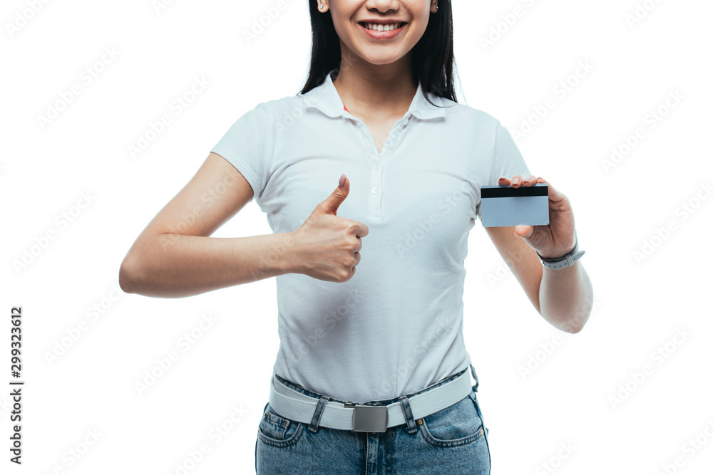 cropped view of happy attractive asian girl holding credit card and showing thumb up isolated on white cropped view of happy attractive asian girl holding credit card and showing thumb up isolated on white