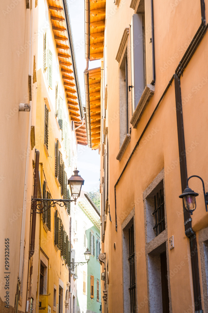 Small alley with colorful houses and lanterns in Rovereto, Italy