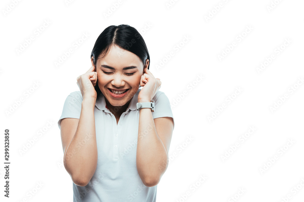 happy attractive asian girl putting fingers in ears isolated on white happy attractive asian girl putting fingers in ears isolated on white