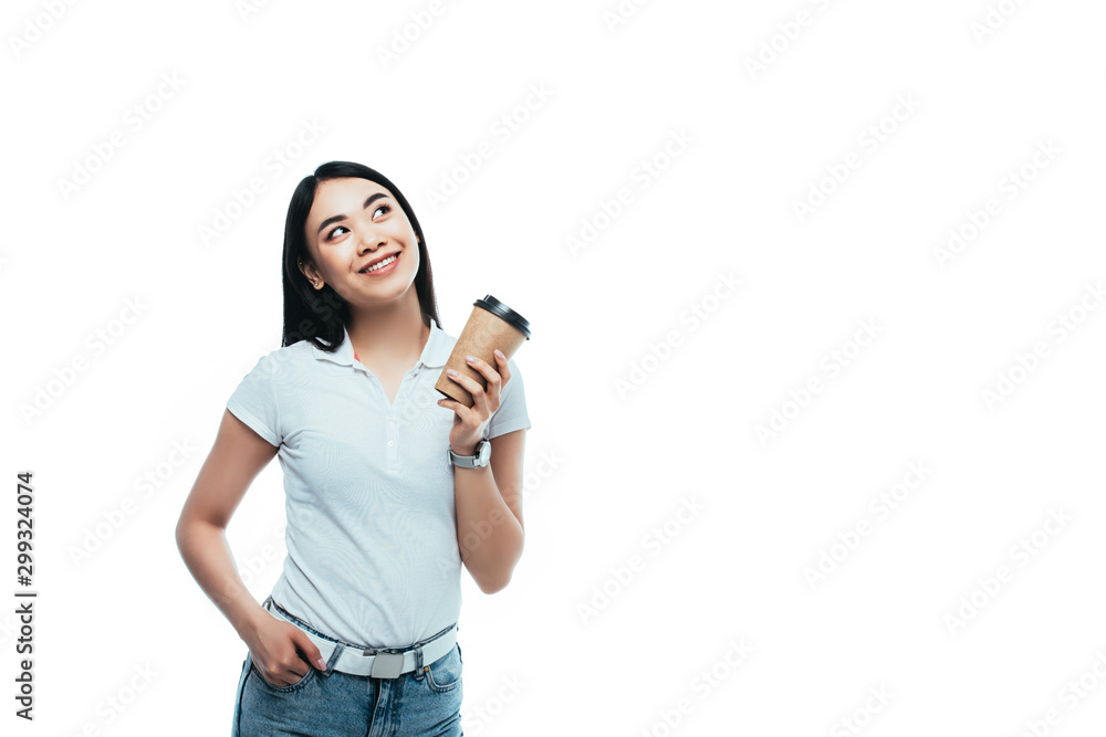 smiling attractive asian girl holding paper cup and looking away isolated on white smiling attractive asian girl holding paper cup and looking away isolated on white