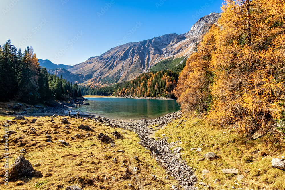 Scenic view of mountain lake at autumn sunny day. Europe, Austria,Tyrol, Lake Obernberg, Stubai Alps.