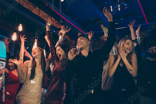 Photo of crazy chilling students dressed in formalwear putting their hands up rejoicing with party started faces with smile screaming shouting with happiness enjoying free time