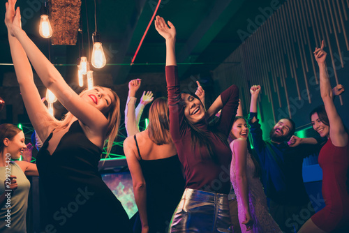 Portrait of delighted girl company corporate visit with group buddies party nightclub on her birthday anniversary raise hands have fun dance wear formalwear dress skirt in discotheque