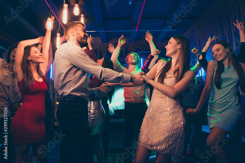 Lets dance my love. Portrait of positive cheerful couple students have wedding party dance on discotheque with lots people crowd wearing formalwear dress skirt in spotlight