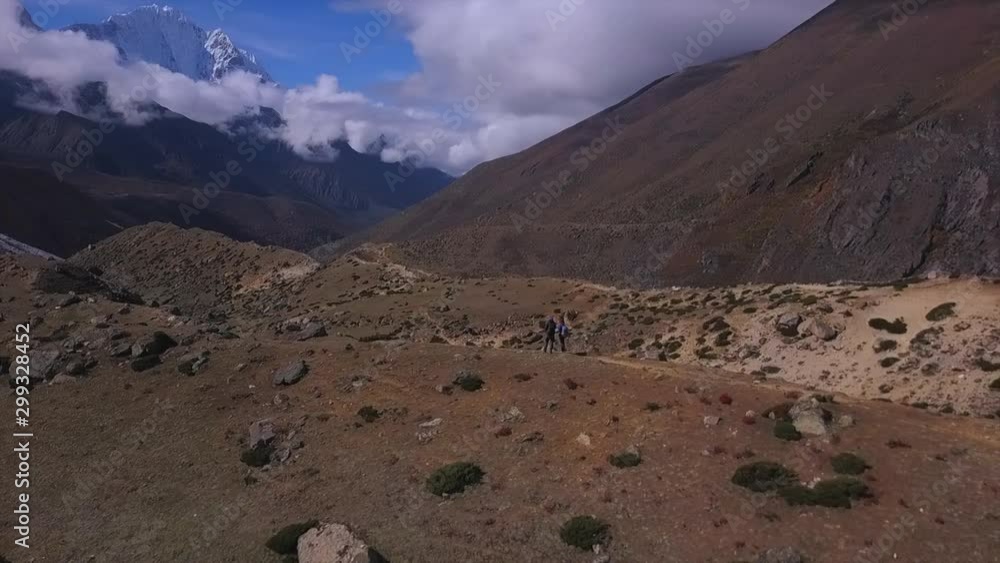 Active hikers hiking, enjoying the view, looking at Himalaya mountains landscape.Tracking to Everest base camp Travel sport lifestyle concept Active hikers hiking, enjoying the view, looking at Himalaya mountains landscape.Tracking to Everest base camp Travel sport lifestyle concept