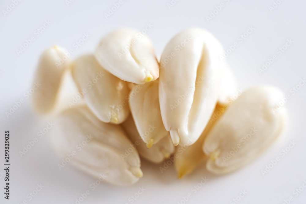 row, line of peeled young almonds on a white background, isolate, nut antioxidant row, line of peeled young almonds on a white background, isolate, nut antioxidant