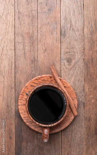 Black coffee in wood cup over grunge wooden table background,top view with copy space