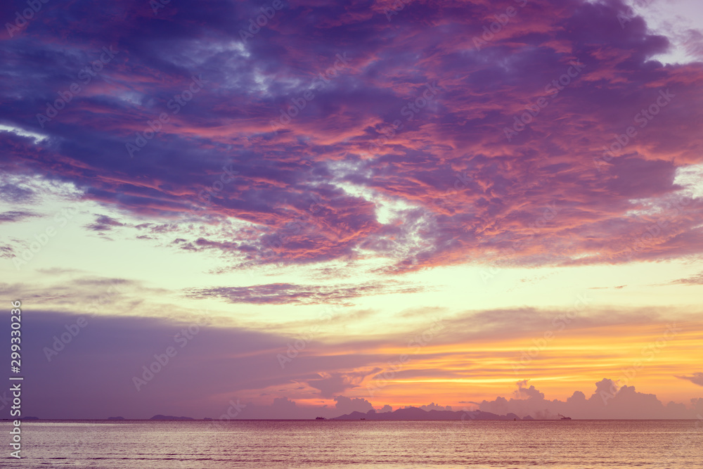 Dramatic  beach sunset with blue sea and purple cloud   yellow sky background,Samui island,Thailand