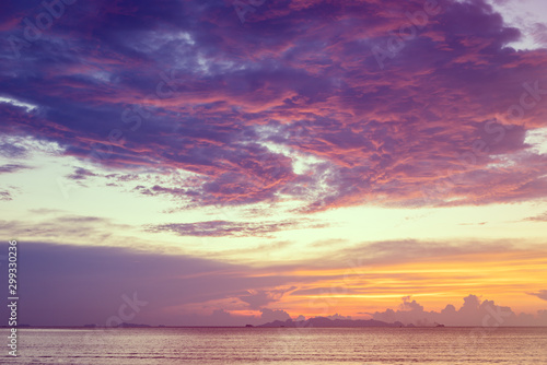 Dramatic  beach sunset with blue sea and purple cloud   yellow sky background Samui island Thailand