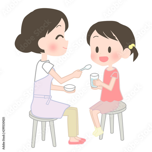 子供に薬を飲ませる母親