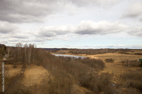 Panorama of the spring landscape with a lake and hills with copses. Izborsk  Pskov region  Russia.