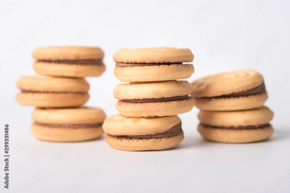 Cookies stuffed with coffee cream stacked on a white background. Cookies stuffed with coffee cream stacked on a white background.
