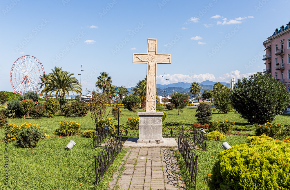 A large cross with a crucifix stands on the Cadet Memorial on the waterfront of Batumi city - the capital of Adjara in Georgia A large cross with a crucifix stands on the Cadet Memorial on the waterfront of Batumi city - the capital of Adjara in Georgia