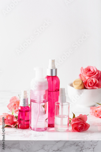 bottles skincare lotion serum medical rose flowers. organic natural cosmetic