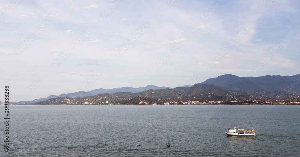 Evening view from Ferris wheel to Caucasus Mountains and the Black Sea Bay on the coast of Batumi city in Georgia