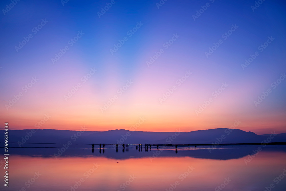 A group of photographers taking pictures of sunrise on the shore of the Dead Sea A group of photographers taking pictures of sunrise on the shore of the Dead Sea