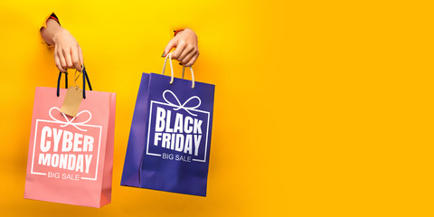 Hands holding gift boxes with black friday lettering on yellow background. Concept of sales, black friday, cyber monday, finance, business, money. Online shops and payments bill. Copyspace for ad.