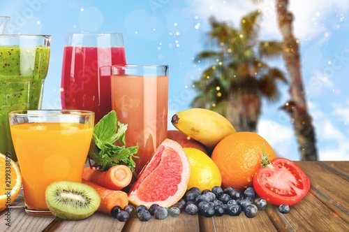 Fototapeta Naklejka Na Ścianę i Meble -  Tasty fruits  and juice with vitamins on background