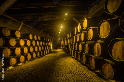 Barrels of wine in the wine cellar one of the famous wineries in Porto in Portugal  which is making an amazing wine and port wine.