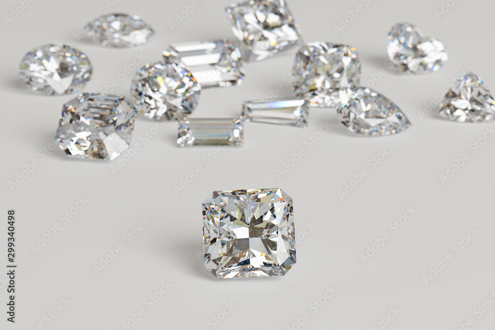 Variously cut diamonds scattered on white background with a radiant cut stone on foreground. Variously cut diamonds scattered on white background with a radiant cut stone on foreground.