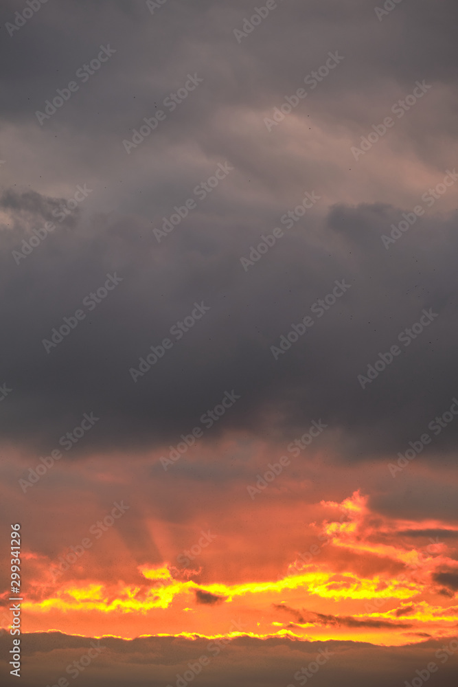 Golden sunrise on a background of gray clouds