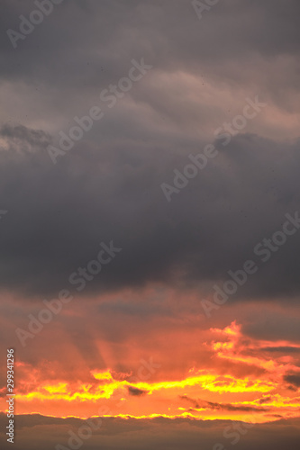 Golden sunrise on a background of gray clouds