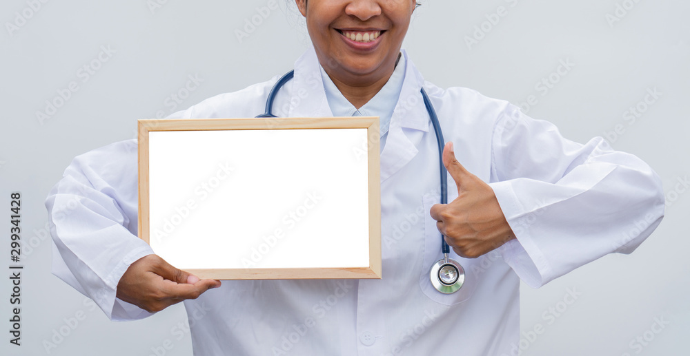 professional female doctor in white coat over white isolated background with white blank board and Thumbs up and smile. Concept of healthcare, science and medicine concept professional female doctor in white coat over white isolated background with white blank board and Thumbs up and smile. Concept of healthcare, science and medicine concept