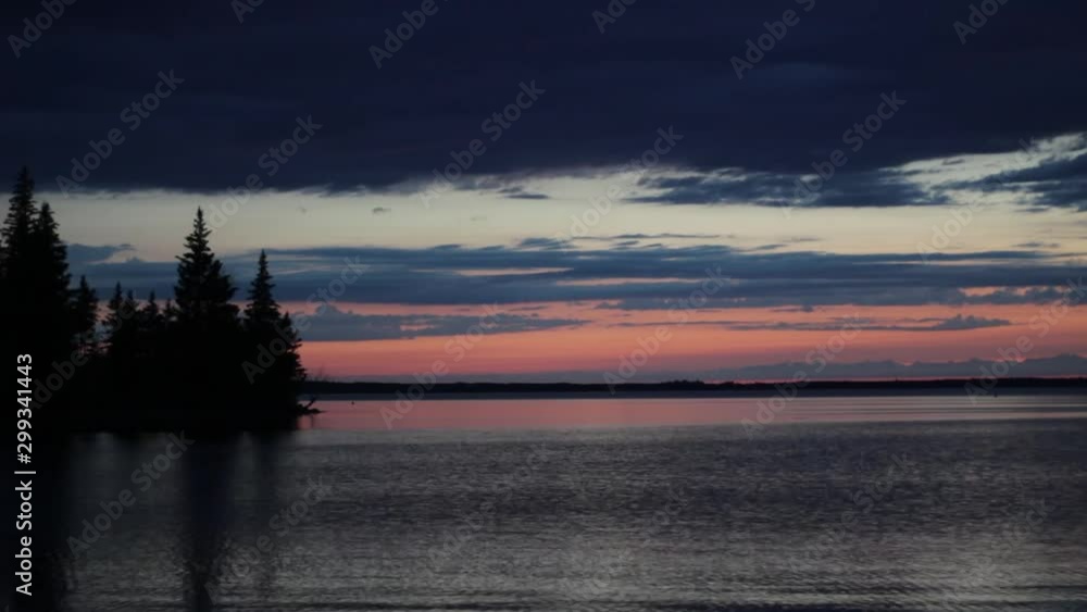 Timelapse Sunset Landscape with Sky and Water in Riding Mountain National Park in Manitoba Canada Timelapse Sunset Landscape with Sky and Water in Riding Mountain National Park in Manitoba Canada