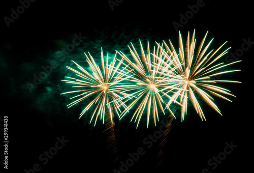Firework with green smoke on a black background.
