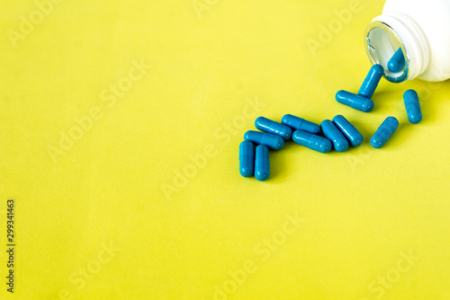 blue pills on yellow abstract background