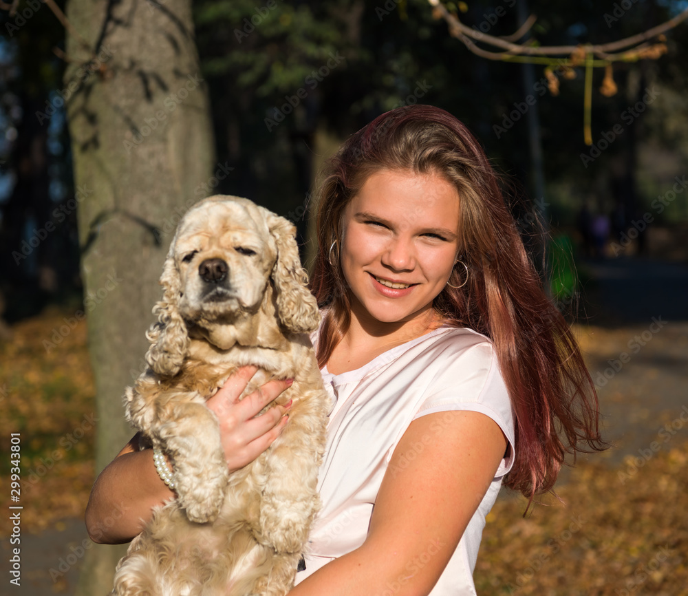 Cute teen girl with a dog posing in summy autumn park Cute teen girl with a dog posing in summy autumn park