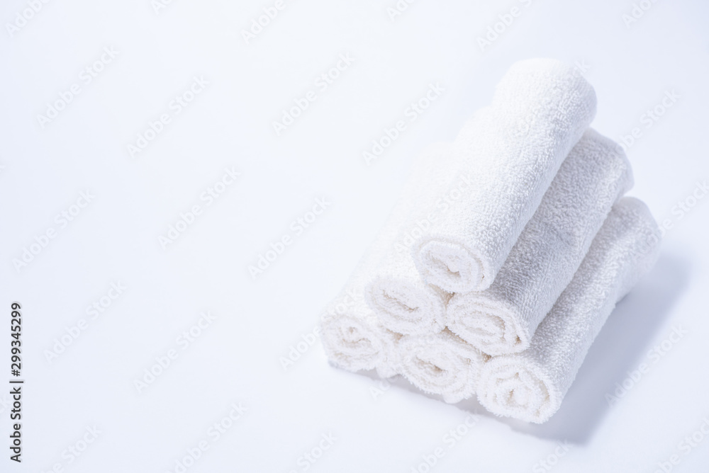Gently rolled terry towels for spa or massage on a white background Gently rolled terry towels for spa or massage on a white background