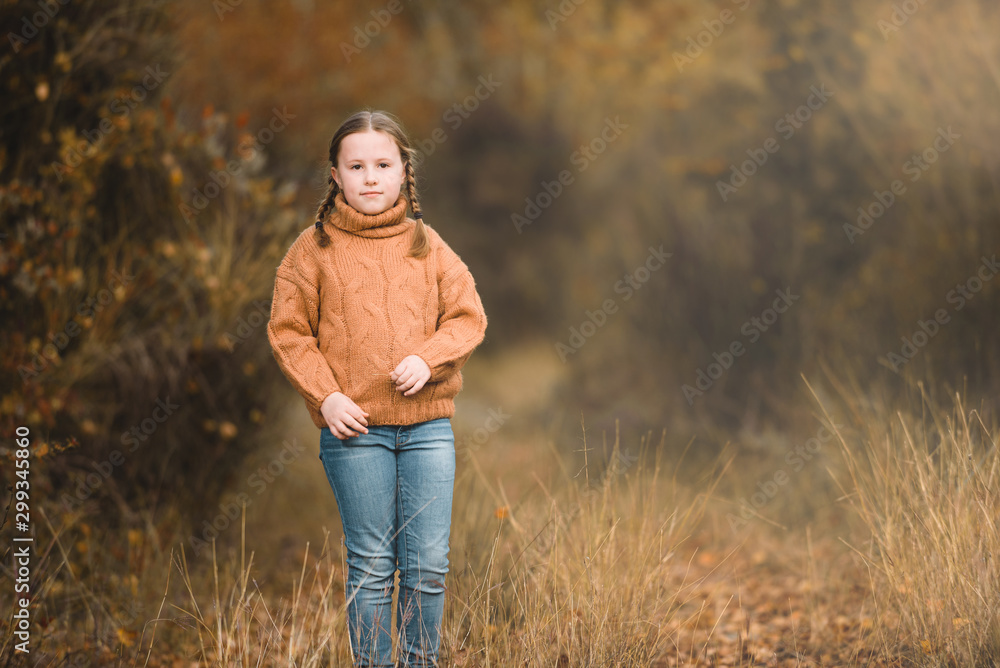 Smiling beautiful girl in the autumn park.