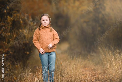 Smiling beautiful girl in the autumn park.