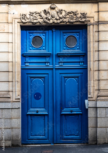 Photography Typical design style of large antique blue wooden door on the streets of Paris France