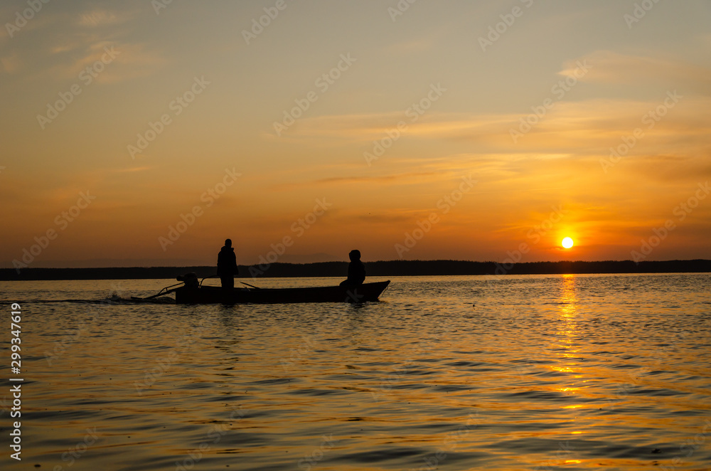 The fishermen and boat silhouette