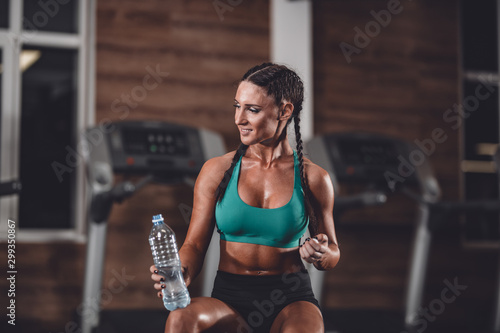 Fit girl rest after training and drink water