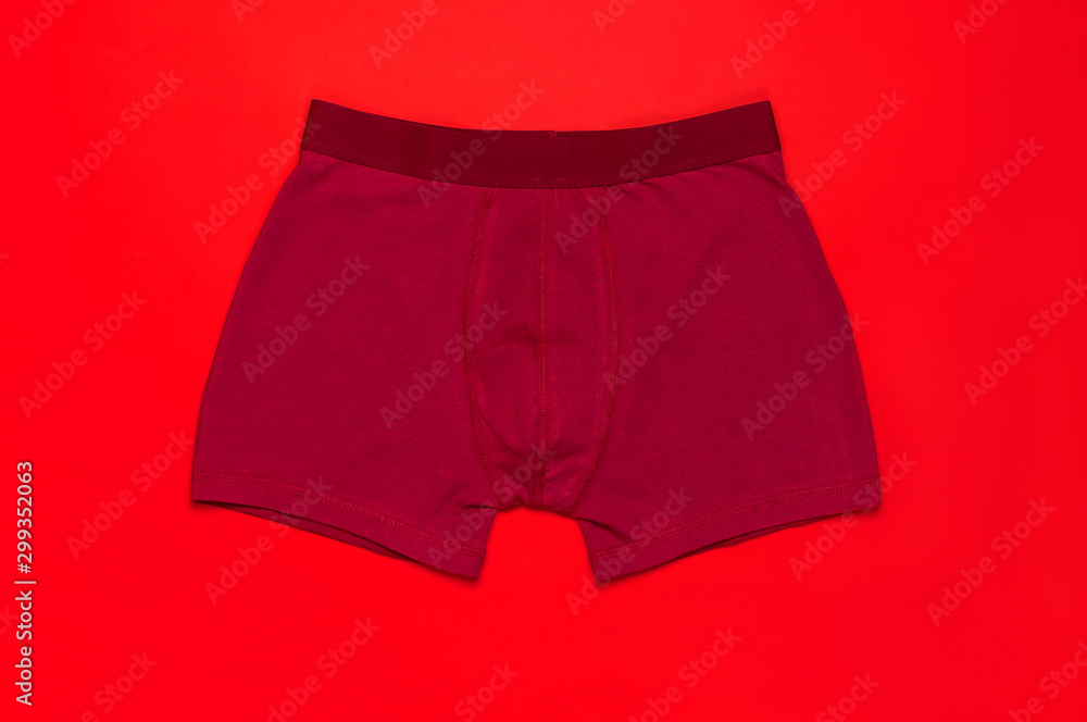 Men's underwear, red burgundy underpants on red background flat lay top view copy space. Fashion blog, natural underwear, advertising, shopping concept. Pants boxers Men's underwear, red burgundy underpants on red background flat lay top view copy space. Fashion blog, natural underwear, advertising, shopping concept. Pants boxers