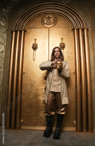 Wallpaper Mural charming shy young teen guy in a medieval style gold suit in a photo Studio is ready to go to a party Torontodigital.ca