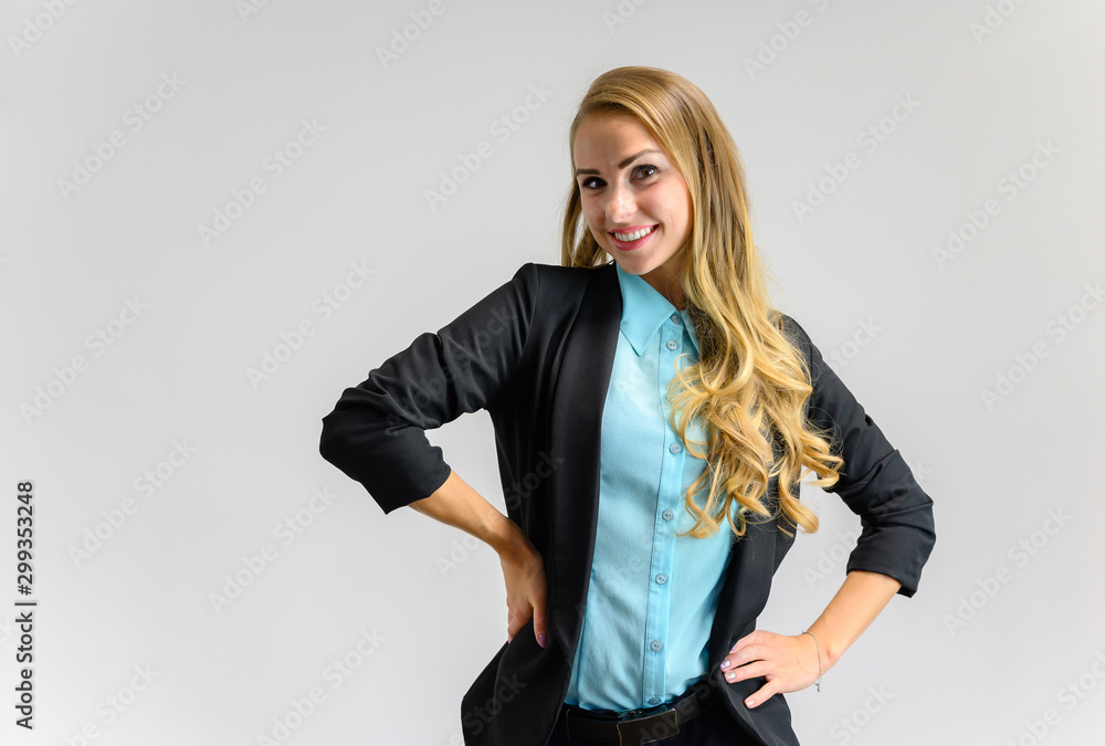 Portrait of a pretty blonde secretary girl with long curly hair in a business suit standing in the studio on a white background with emotions in different poses. Art, business, beauty. Portrait of a pretty blonde secretary girl with long curly hair in a business suit standing in the studio on a white background with emotions in different poses. Art, business, beauty.