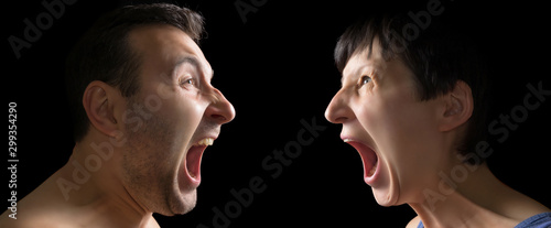 Man and woman yell at each other on black background.