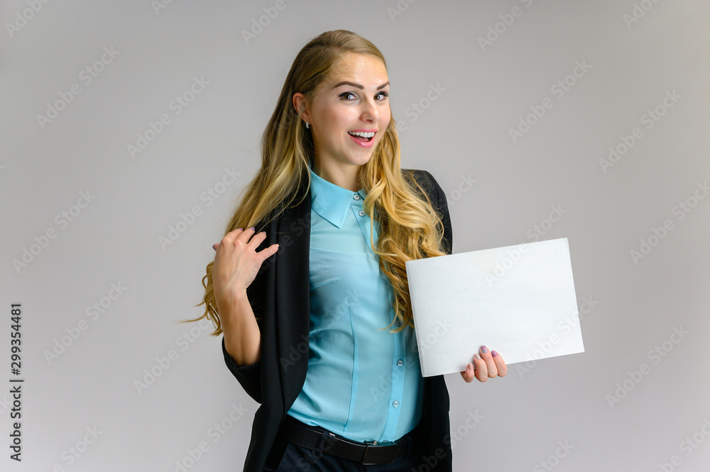 Naklejka premium Portrait of a pretty blonde girl financial secretary with long curly hair in a business suit standing in the studio on a white background with emotions in different poses with a folder in his hands.