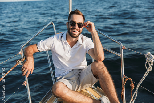Man outdoors posing on yacht in sea. © Drobot Dean