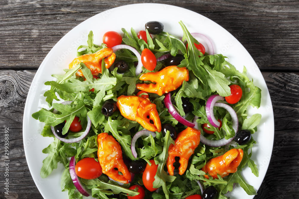 arugula crab clamps salad on a plate