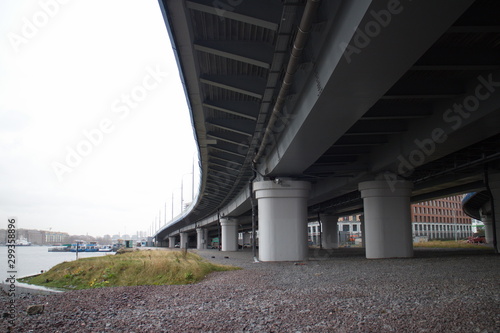 large transport overpass by the river on a cloudy day © Andrey