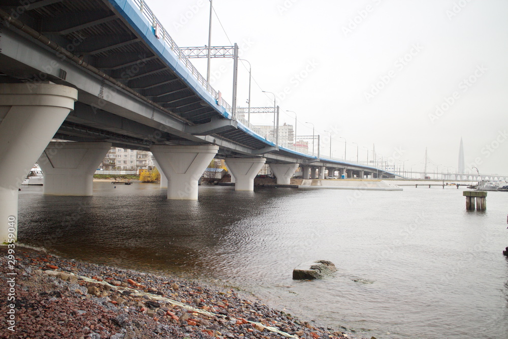 Obraz premium large transport overpass by the river on a cloudy day