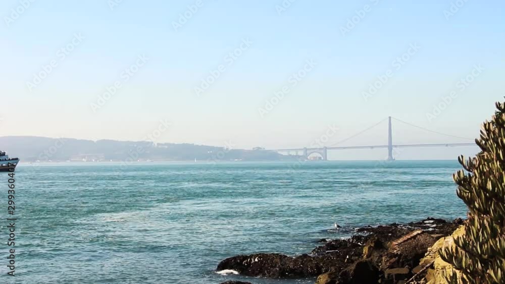 Boat Passing by With Golden Gate Bridge in Distance in San Francisco California Boat Passing by With Golden Gate Bridge in Distance in San Francisco California