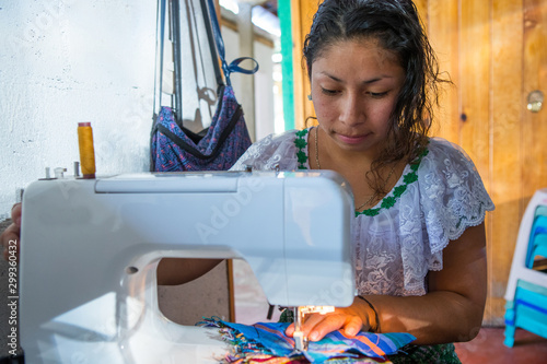 Obraz na płótnie Guatemalan woman working with textiles in in San Juan La Laguna, Lake Atitlan, Guatemala w salonie