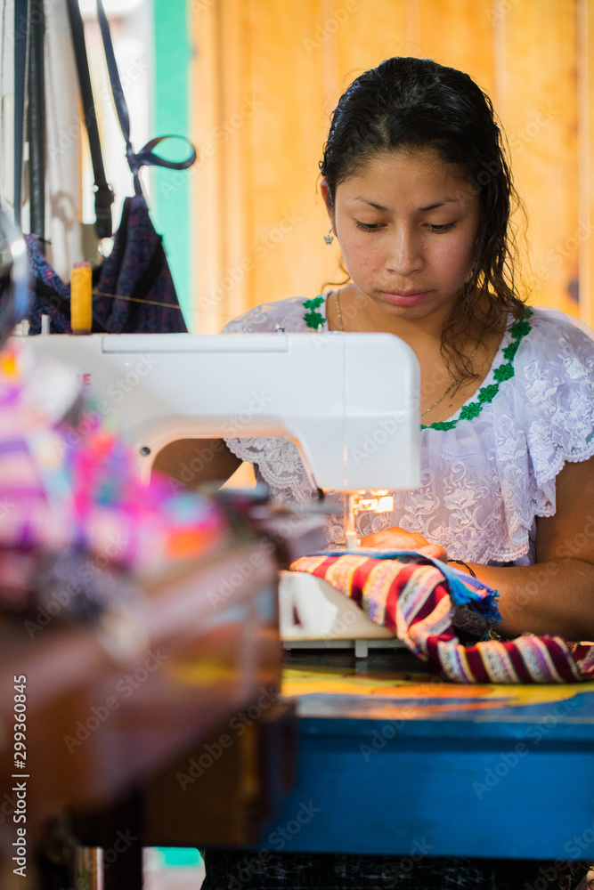 Guatemalan woman working with textiles in in San Juan La Laguna, Lake Atitlan, Guatemala